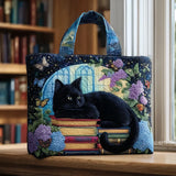 Borsa con gatto nero sui libri